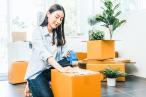 woman packing box to move new home in orlando