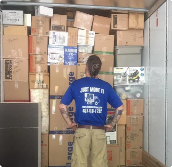 a mover from just move it standing in front of a wall of boxes in orlando