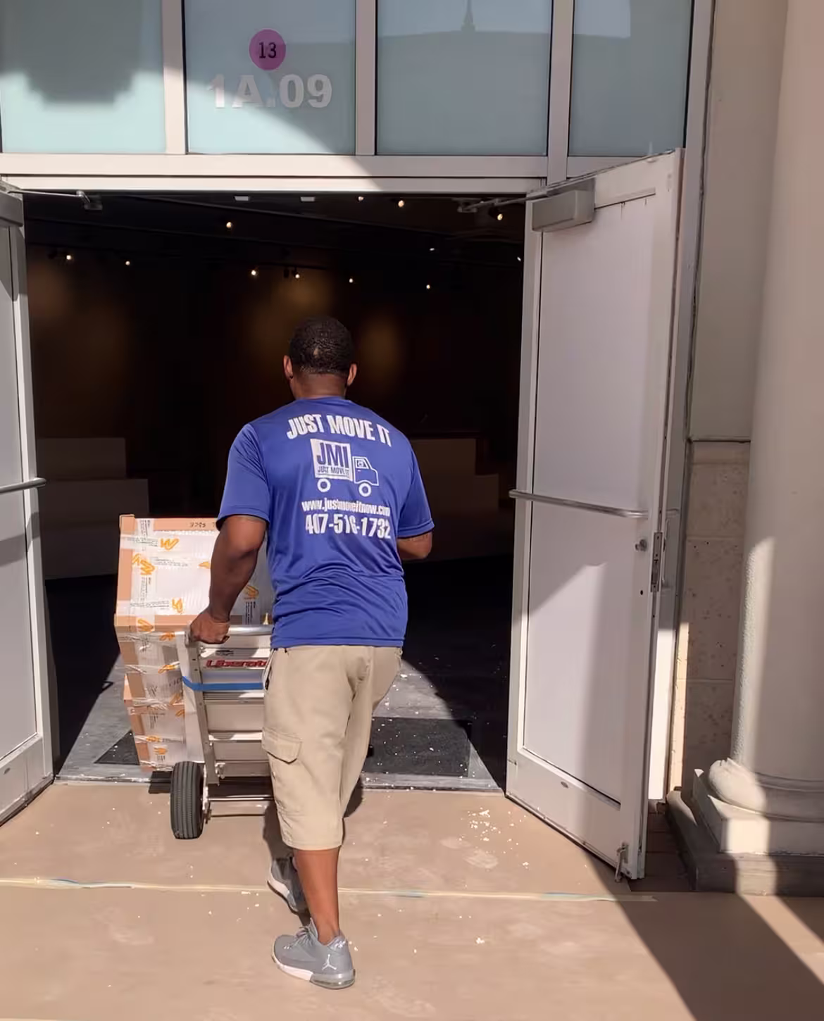 just move it crew member using a hand truck to move boxes for a customer